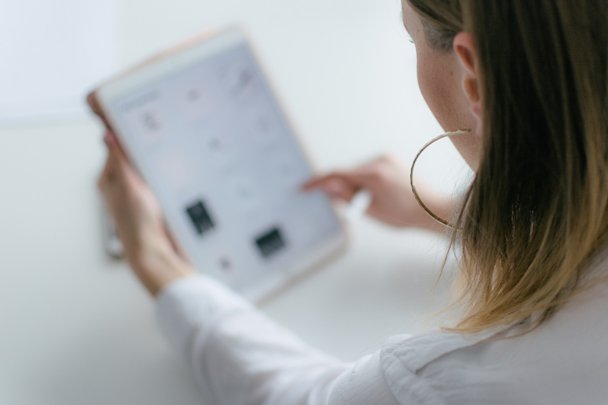 Woman reviewing documentation on a tablet